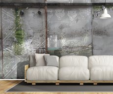 living room wall featuring a wallpaper with ethnic patterns embedded in a cement wall