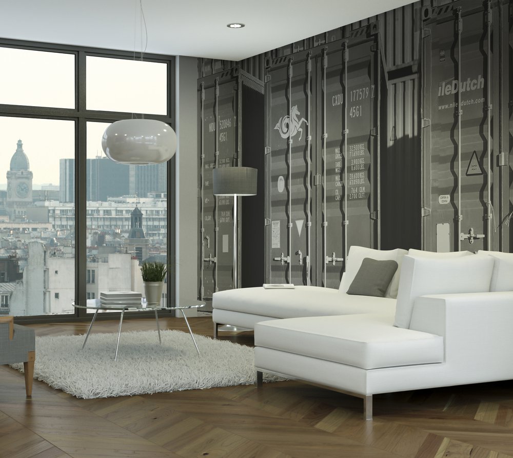 on the wall of this living room overlooking the Gare de Lyon is a wallpaper representing containers in black and white