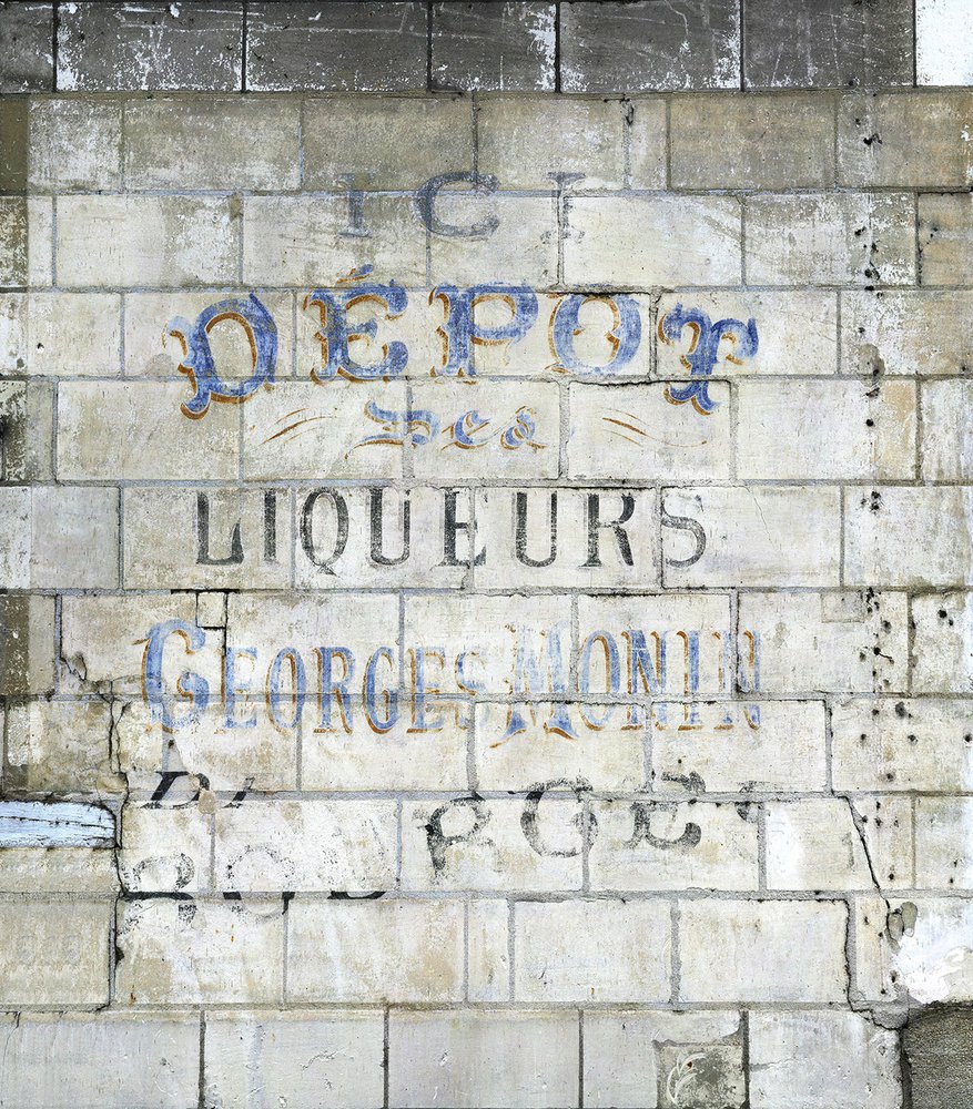 wallpaper shows us an old advertisement of liquor painted on a stone wall